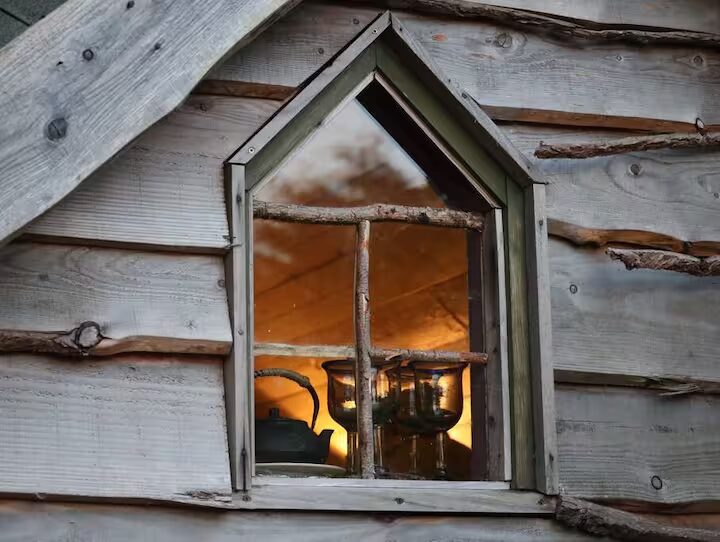 The warm glow of a window at Clachamish House at dusk